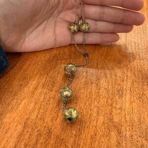 Silver Y-chain with green-and-gold marbled shimmery blown glass beads